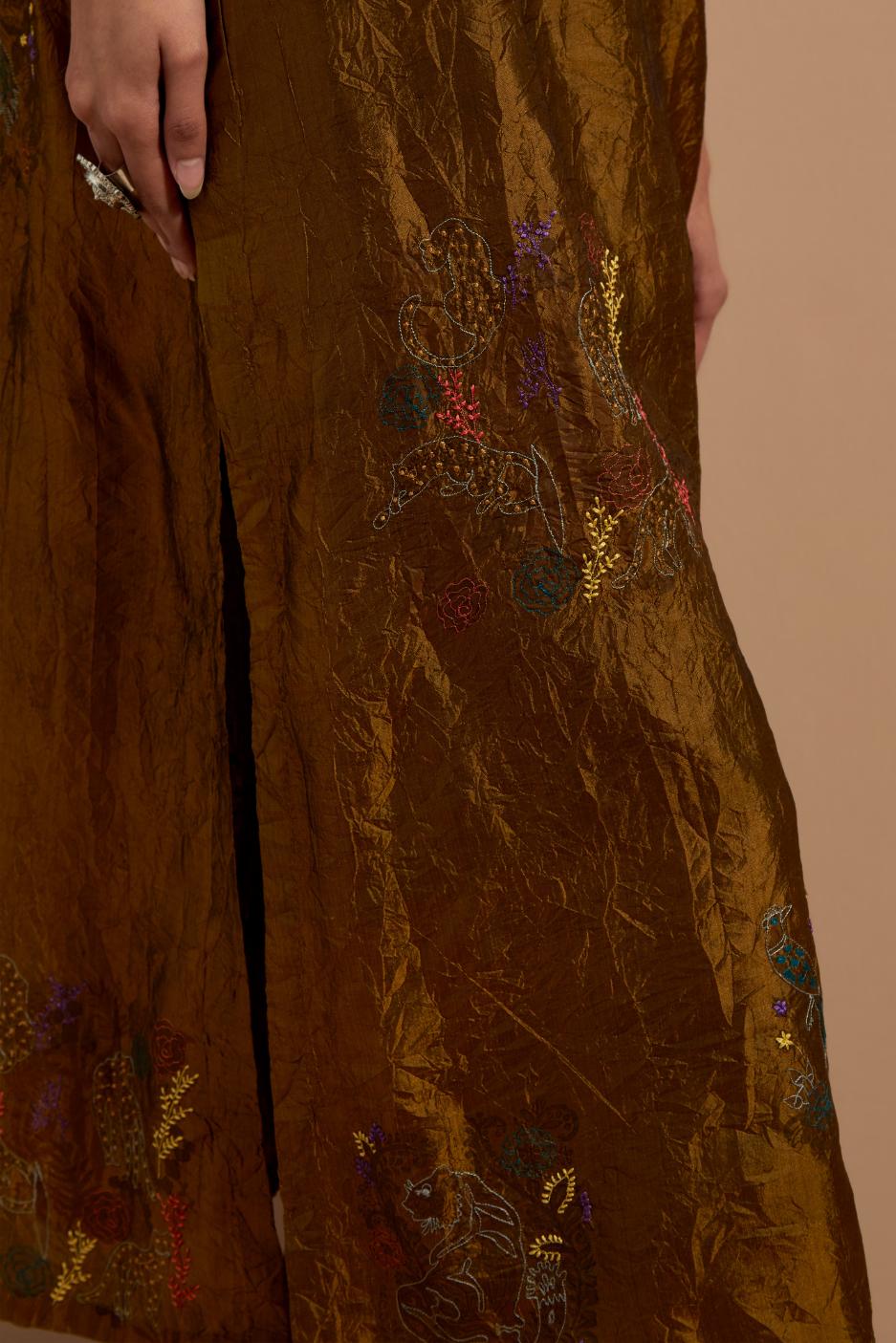 Olive crushed silk hand block printed kurta set with pin tucks at yoke, highlighted with multi colored thread embroidery.
