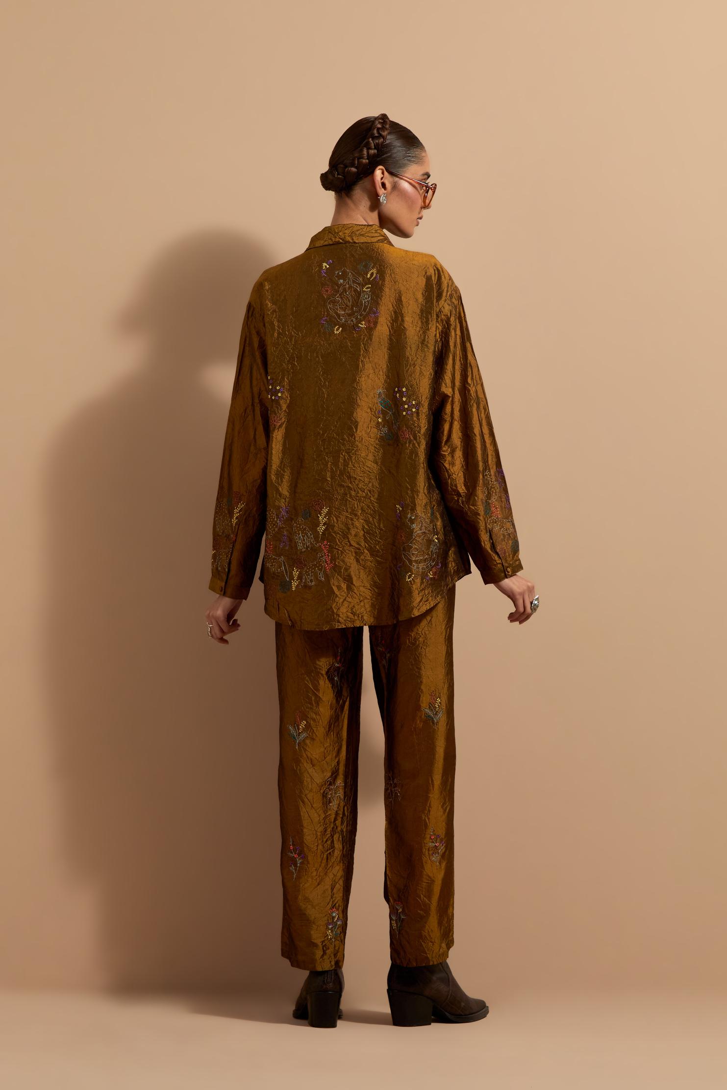 Olive crushed silk hand block printed shirt, highlighted with multi colored thread embroidery, paired with Olive crushed silk hand block printed pants, highlighted with multi colored thread embroidery.