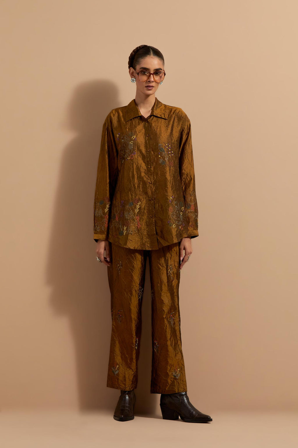 Olive crushed silk hand block printed shirt, highlighted with multi colored thread embroidery, paired with Olive crushed silk hand block printed pants, highlighted with multi colored thread embroidery.