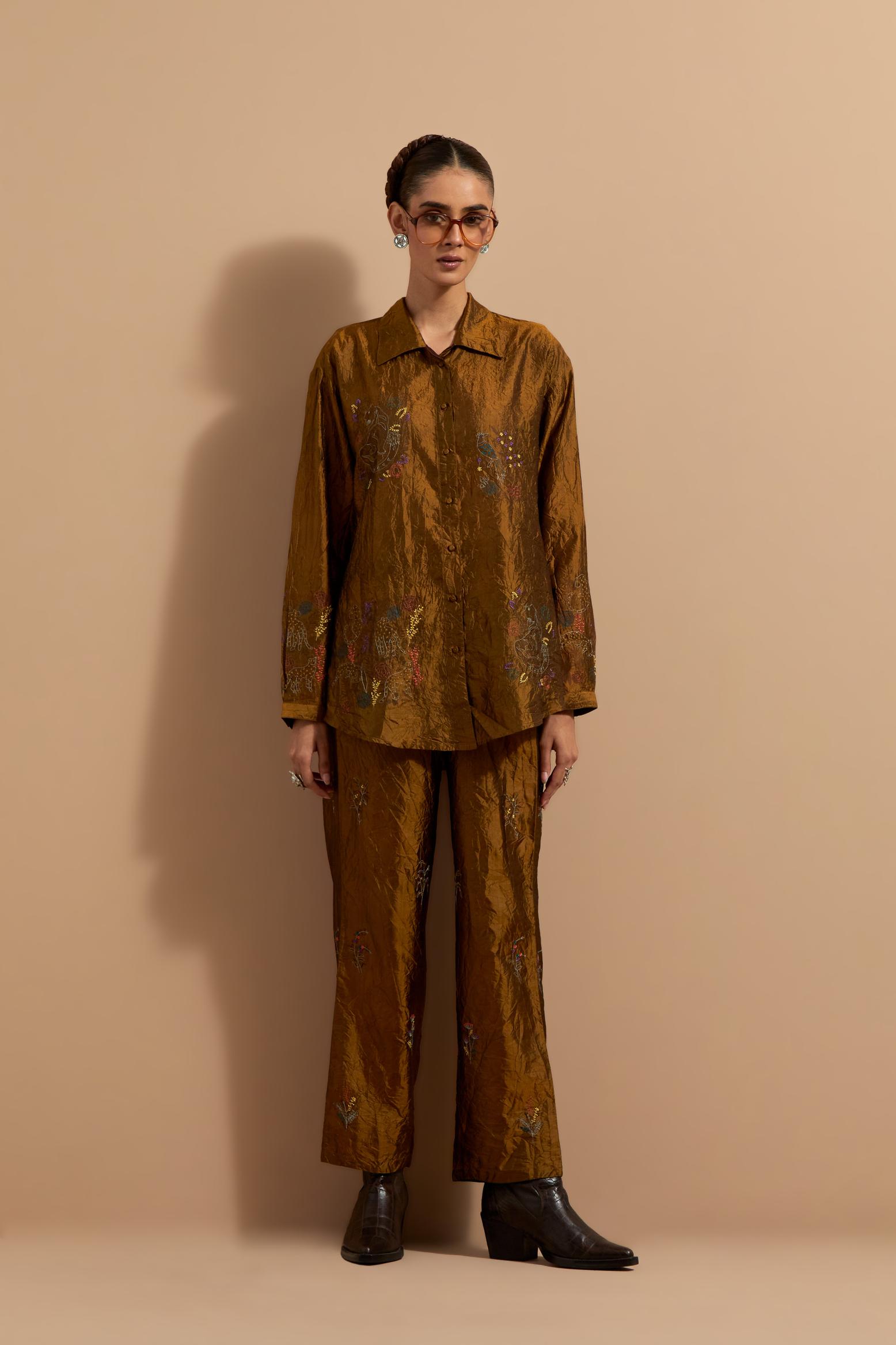 Olive crushed silk hand block printed shirt, highlighted with multi colored thread embroidery, paired with Olive crushed silk hand block printed pants, highlighted with multi colored thread embroidery.