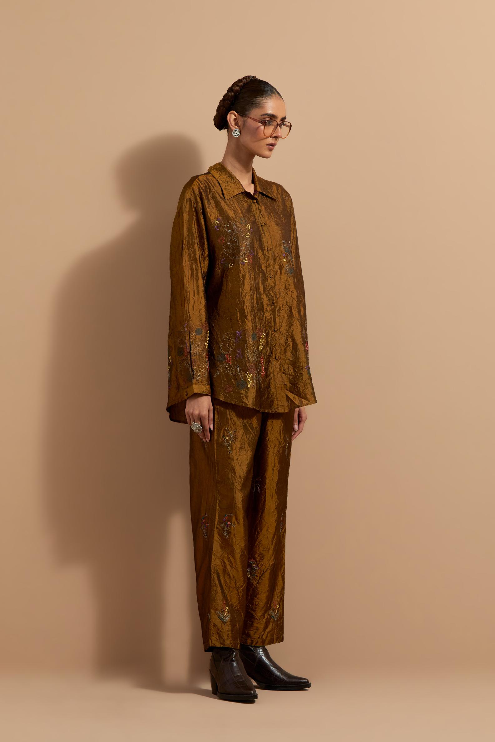 Olive crushed silk hand block printed shirt, highlighted with multi colored thread embroidery, paired with Olive crushed silk hand block printed pants, highlighted with multi colored thread embroidery.