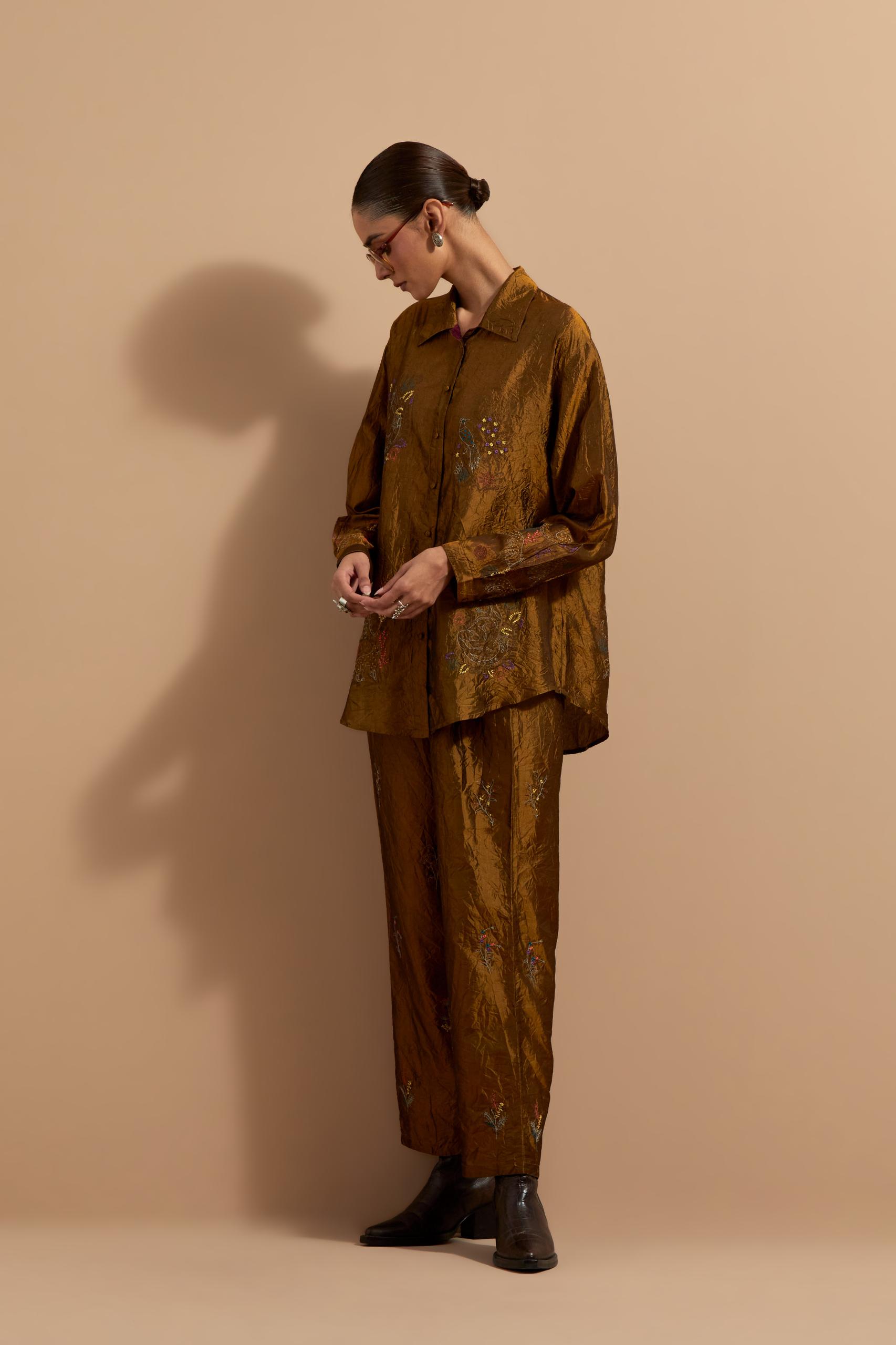 Olive crushed silk hand block printed shirt, highlighted with multi colored thread embroidery, paired with Olive crushed silk hand block printed pants, highlighted with multi colored thread embroidery.