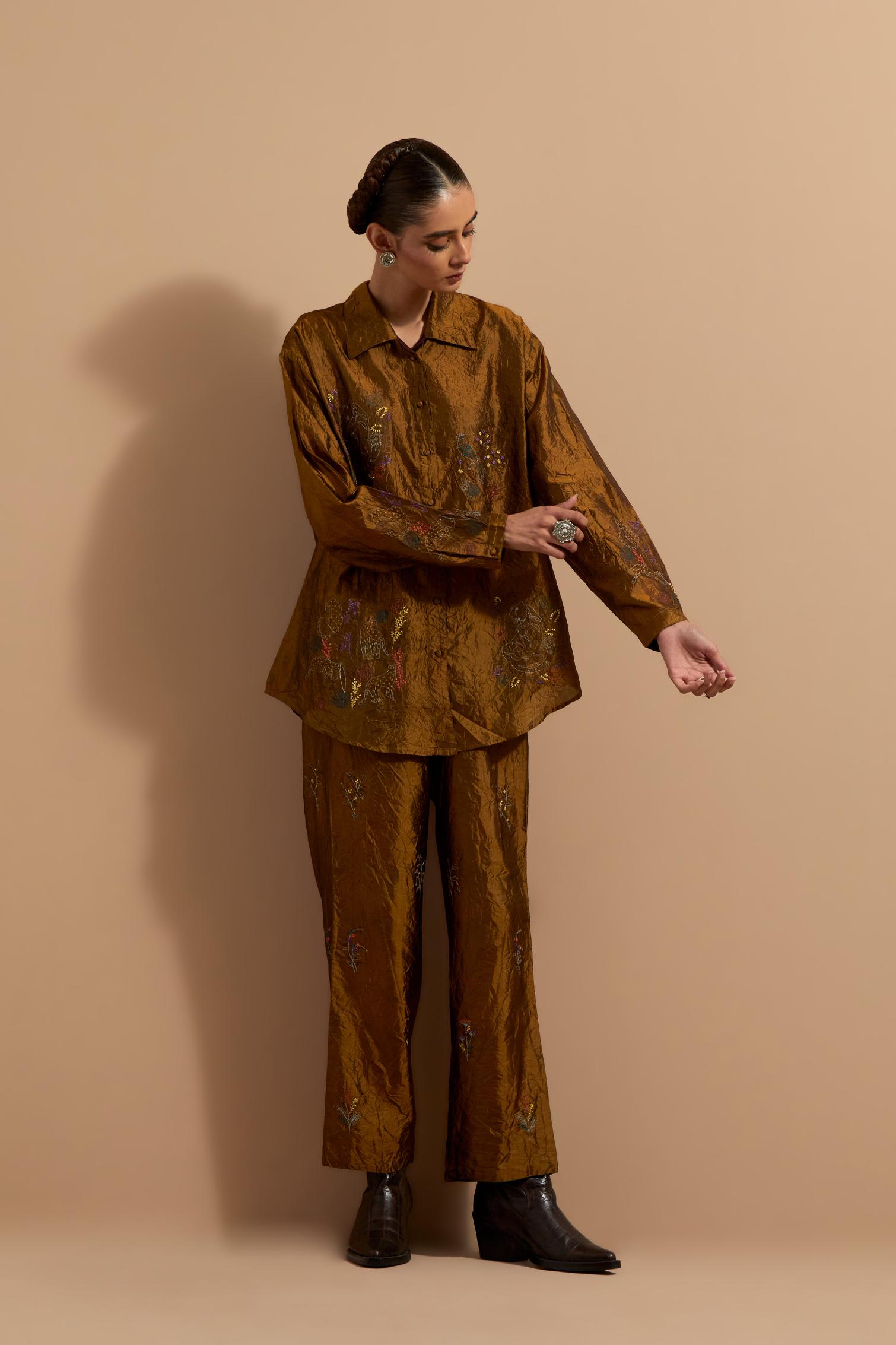 Olive crushed silk hand block printed shirt, highlighted with multi colored thread embroidery, paired with Olive crushed silk hand block printed pants, highlighted with multi colored thread embroidery.