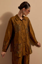 Olive crushed silk hand block printed shirt, highlighted with multi colored thread embroidery, paired with Olive crushed silk hand block printed pants, highlighted with multi colored thread embroidery.