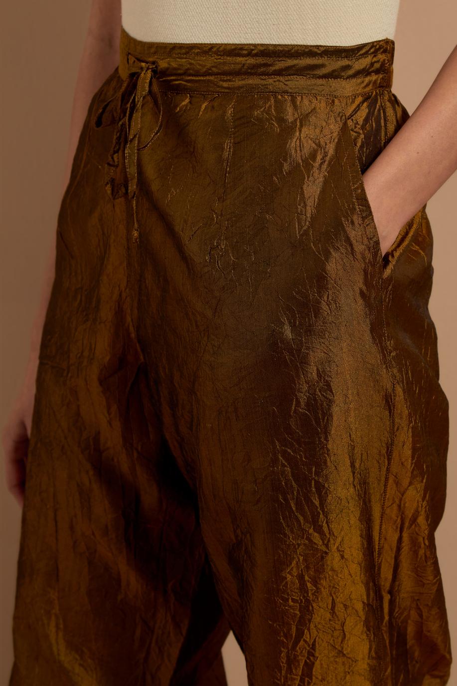 Olive crushed silk hand block printed pants with pin tucks detailing at hem.