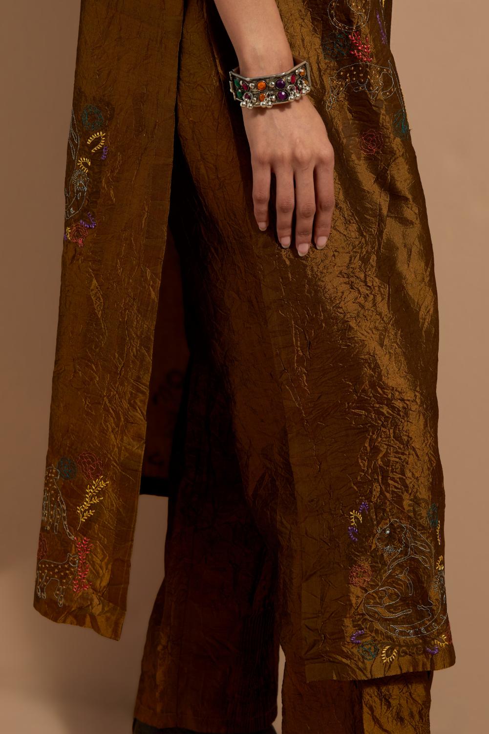 Olive crushed silk hand block printed straight kurta set, highlighted with multi colored thread embroidery.