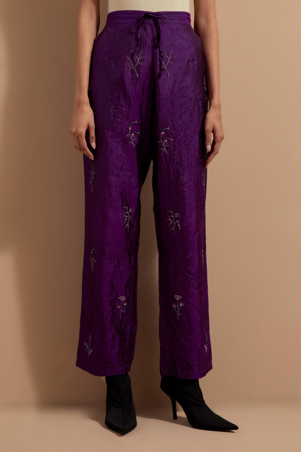 Purple crushed silk hand block printed pants, highlighted with multi colored thread embroidery.