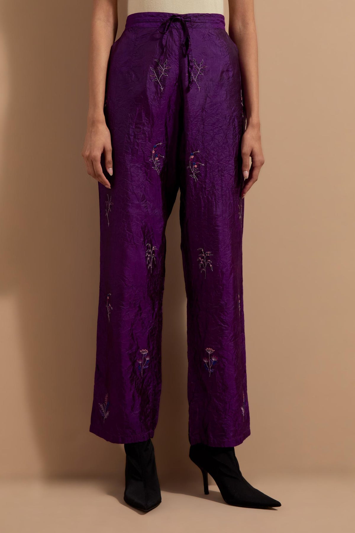 Purple crushed silk hand block printed pants, highlighted with multi colored thread embroidery.