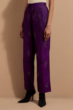 Purple crushed silk hand block printed pants, highlighted with multi colored thread embroidery.