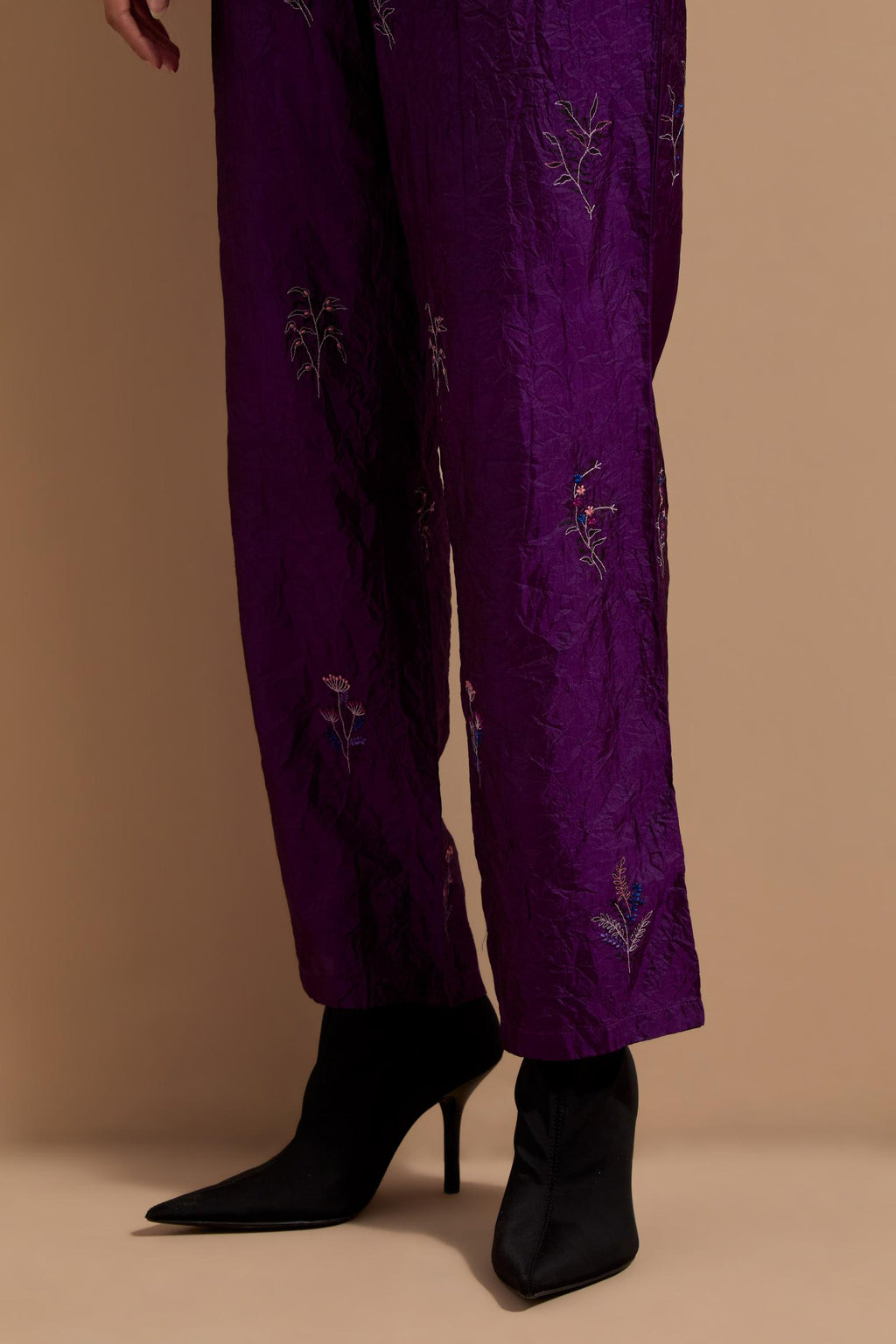 Purple crushed silk hand block printed pants, highlighted with multi colored thread embroidery.