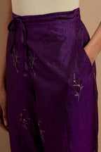 Purple crushed silk hand block printed pants, highlighted with multi colored thread embroidery.