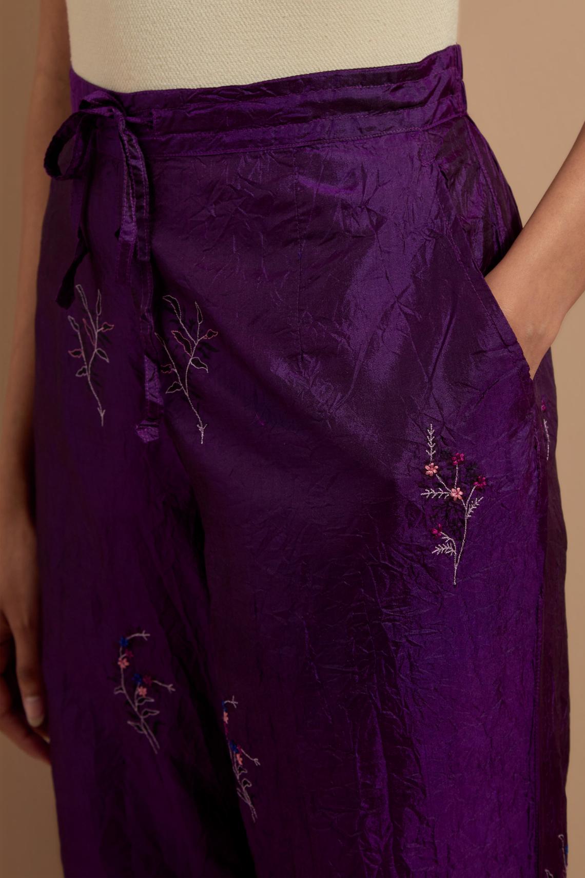 Purple crushed silk hand block printed pants, highlighted with multi colored thread embroidery.
