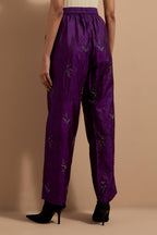 Purple crushed silk hand block printed pants, highlighted with multi colored thread embroidery.