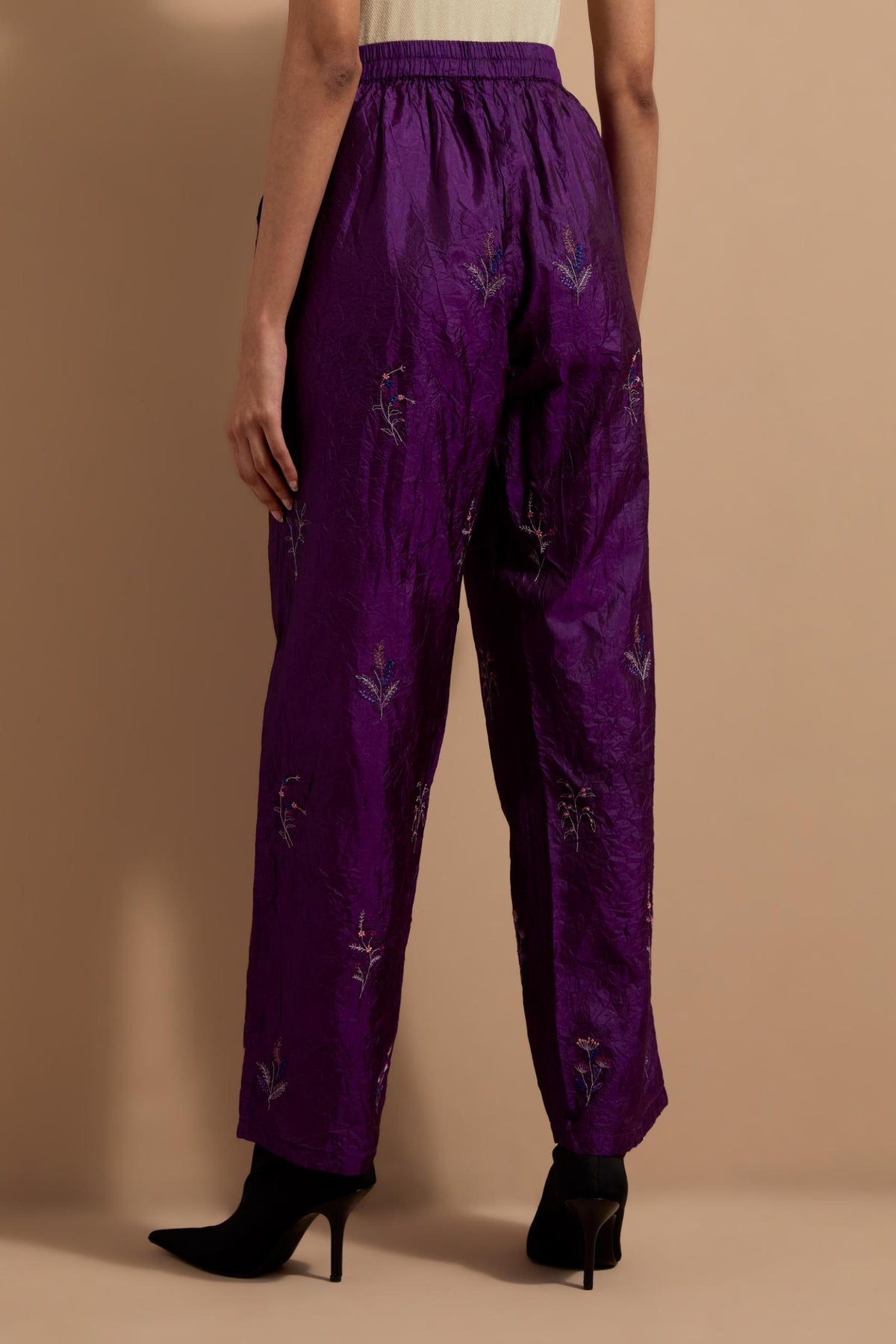 Purple crushed silk hand block printed pants, highlighted with multi colored thread embroidery.