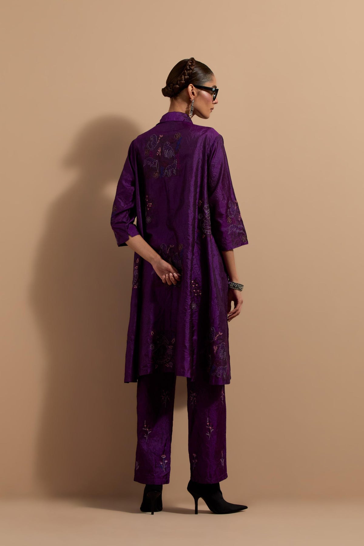 Purple crushed silk A-line short kurta set with hand block print, highlighted with multi colored thread embroidery.