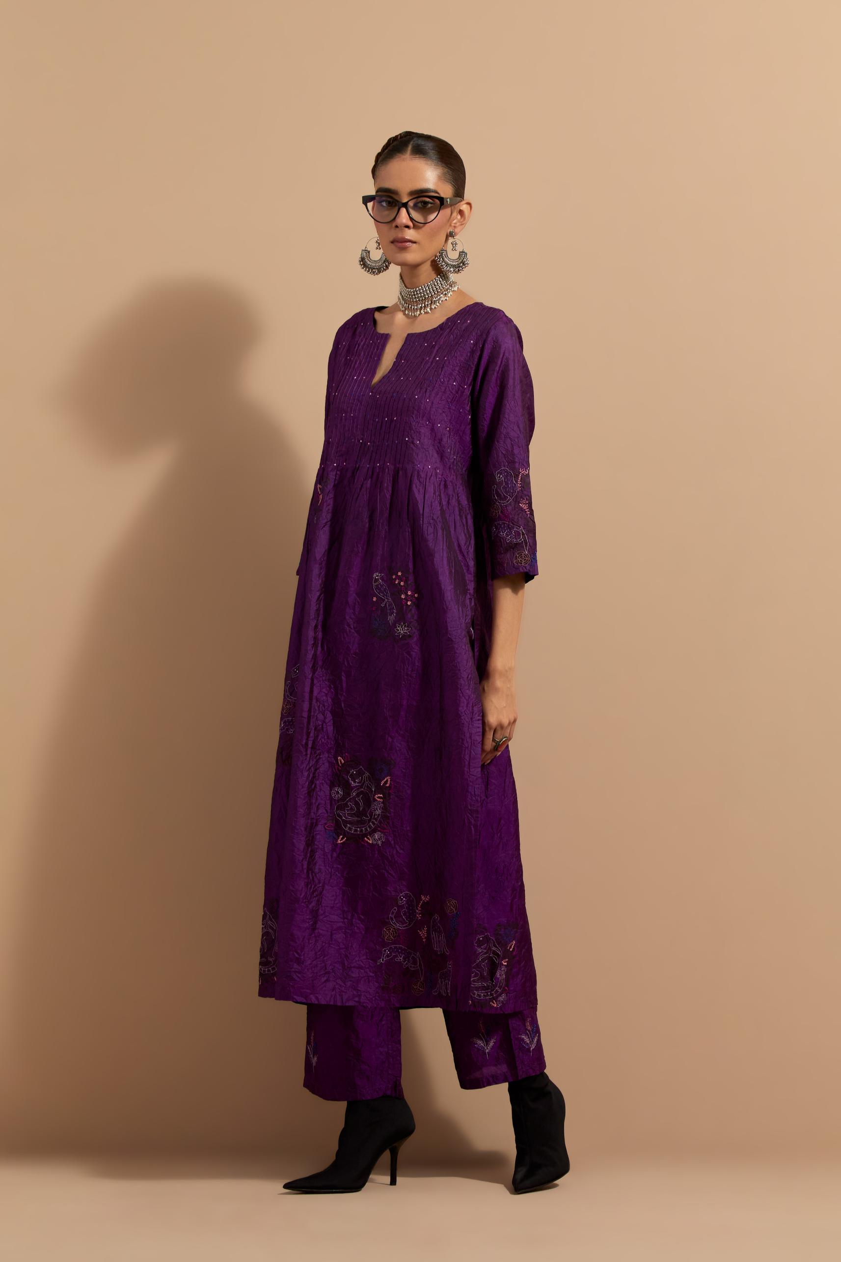 Purple crushed silk hand block printed kurta set with pin tucks at yoke, highlighted with multi colored thread embroidery.