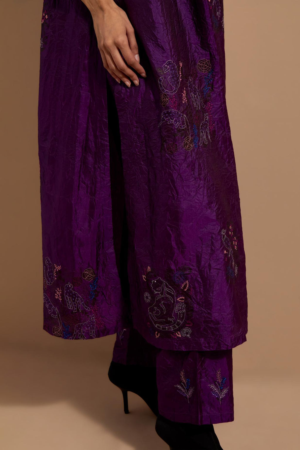 Purple crushed silk hand block printed kurta set with pin tucks at yoke, highlighted with multi colored thread embroidery.