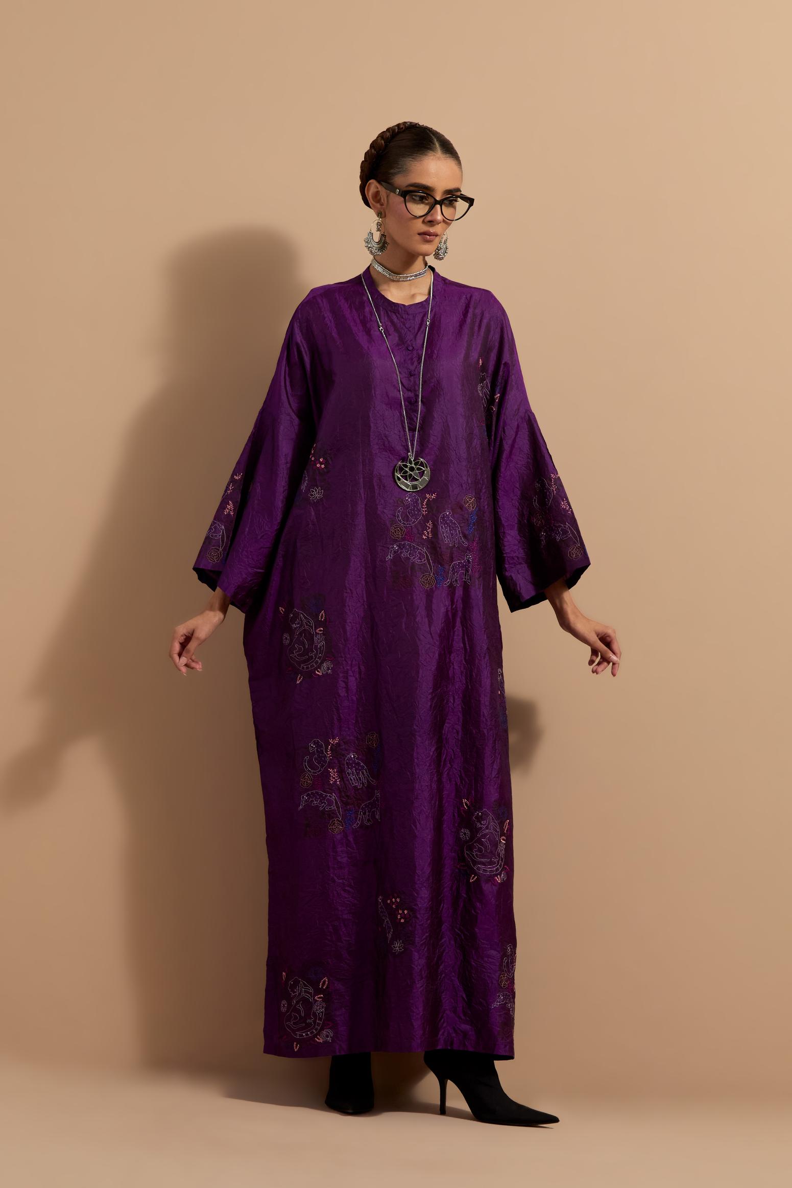 Purple crushed silk hand block printed long kaftan, highlighted with multi colored thread embroidery, paired with Red hand crushed block printed silk stole with quilted embroidery and beaded tassels.