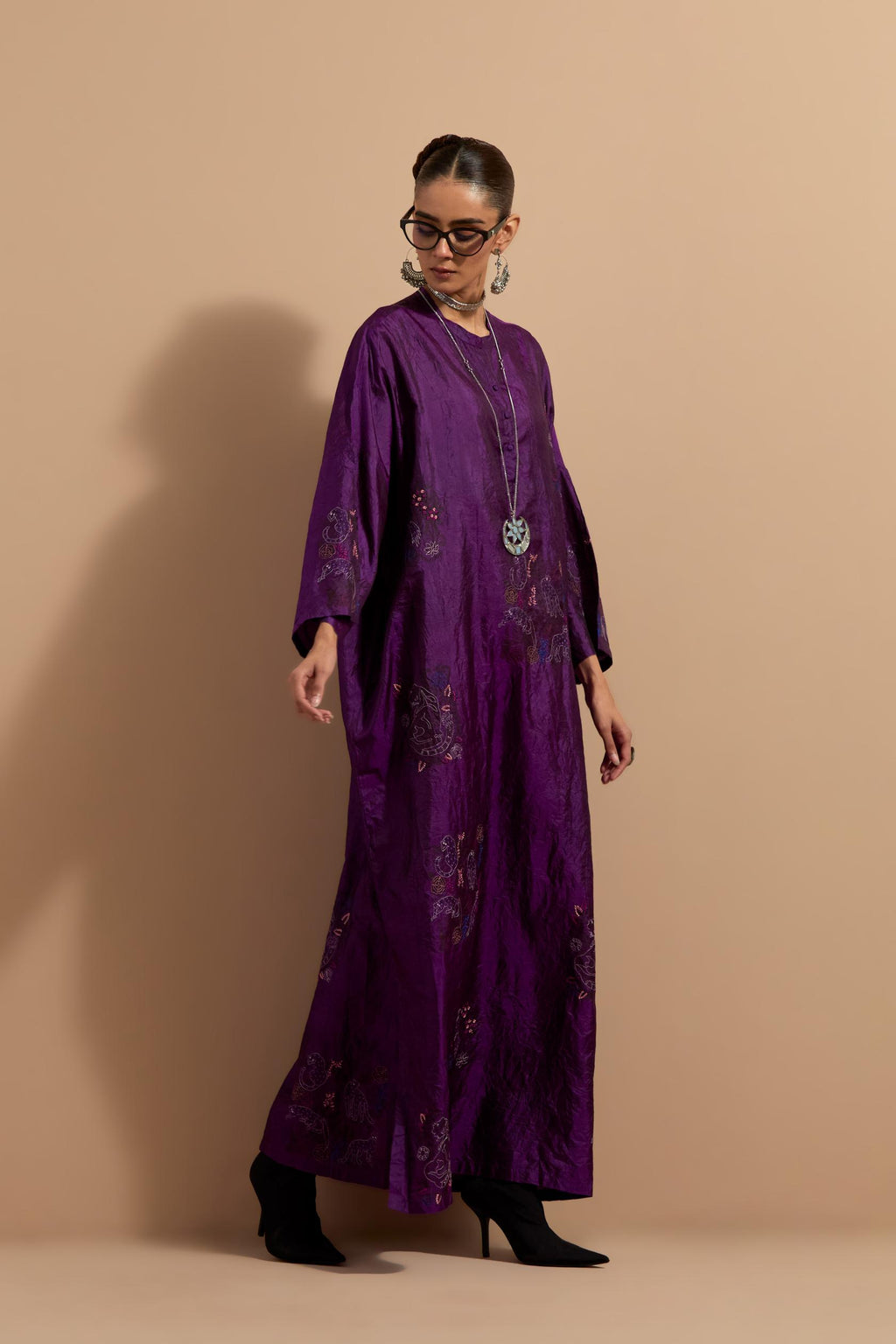 Purple crushed silk hand block printed long kaftan, highlighted with multi colored thread embroidery, paired with Red hand crushed block printed silk stole with quilted embroidery and beaded tassels.