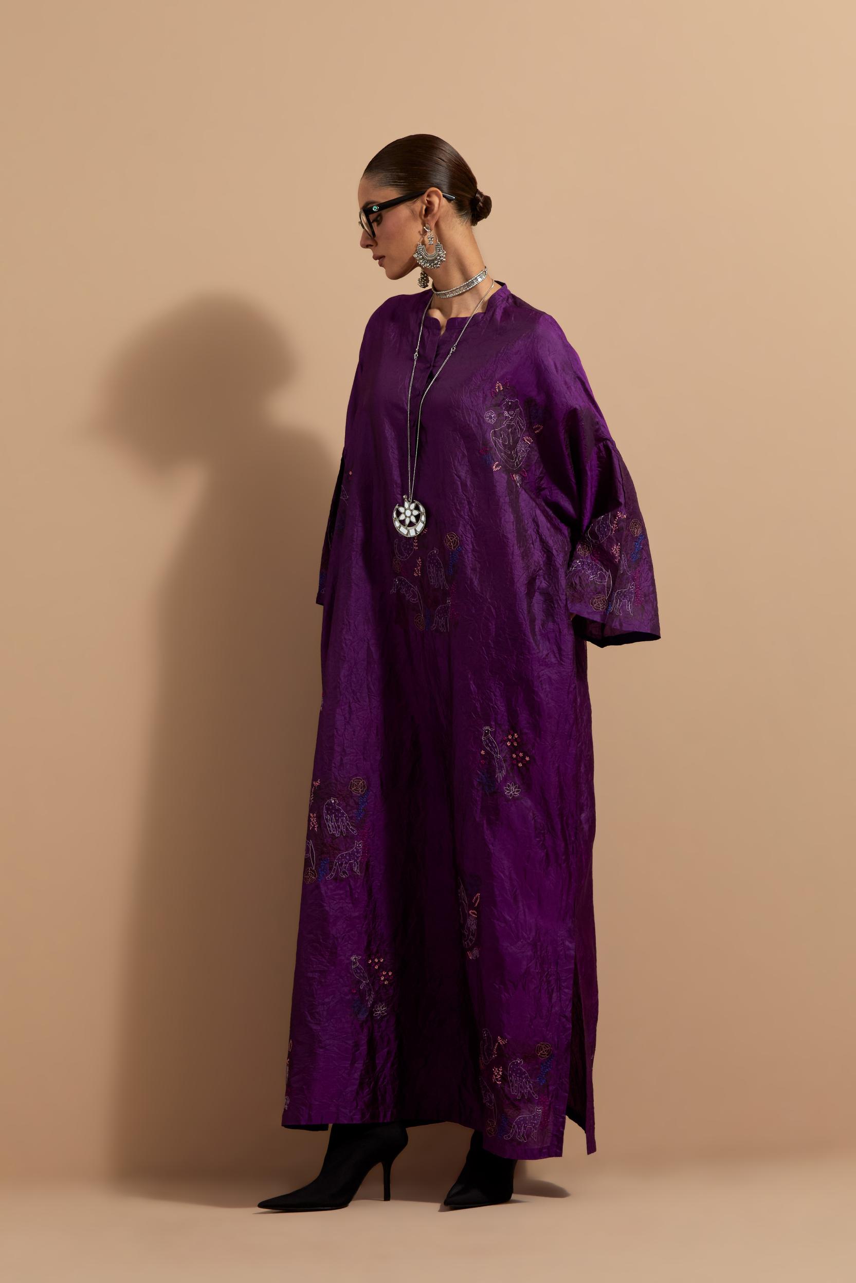 Purple crushed silk hand block printed long kaftan, highlighted with multi colored thread embroidery, paired with Red hand crushed block printed silk stole with quilted embroidery and beaded tassels.