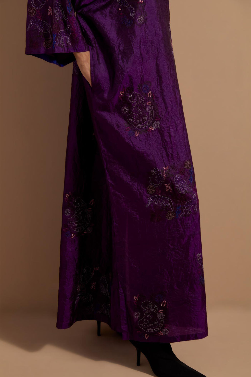 Purple crushed silk hand block printed long kaftan, highlighted with multi colored thread embroidery, paired with Red hand crushed block printed silk stole with quilted embroidery and beaded tassels.