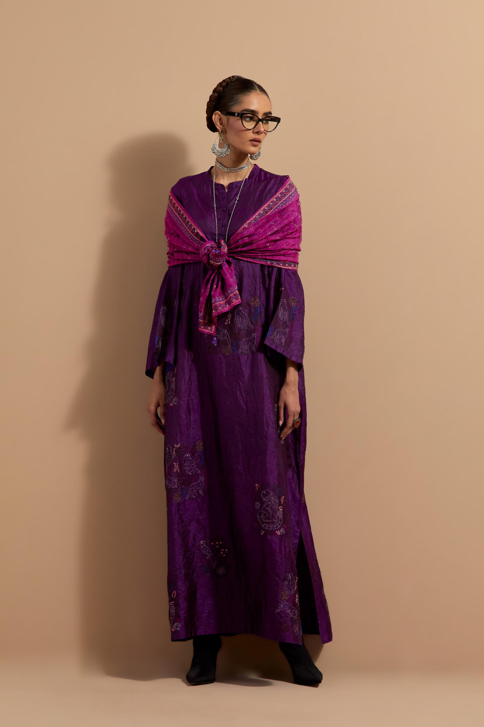 Purple crushed silk hand block printed long kaftan, highlighted with multi colored thread embroidery, paired with Red hand crushed block printed silk stole with quilted embroidery and beaded tassels.