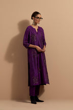 Purple crushed silk hand block printed straight kurta set, highlighted with multi colored thread embroidery.