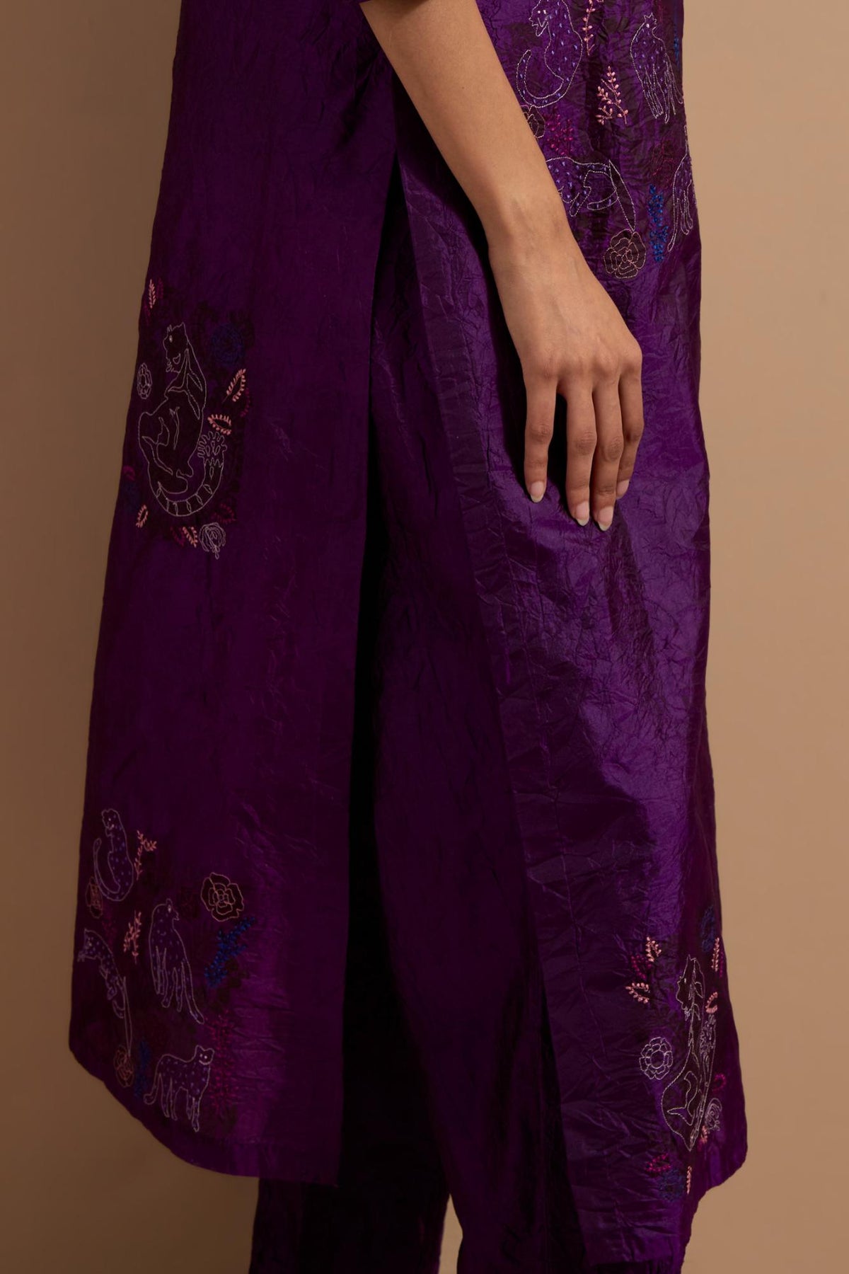 Purple crushed silk hand block printed straight kurta set, highlighted with multi colored thread embroidery.