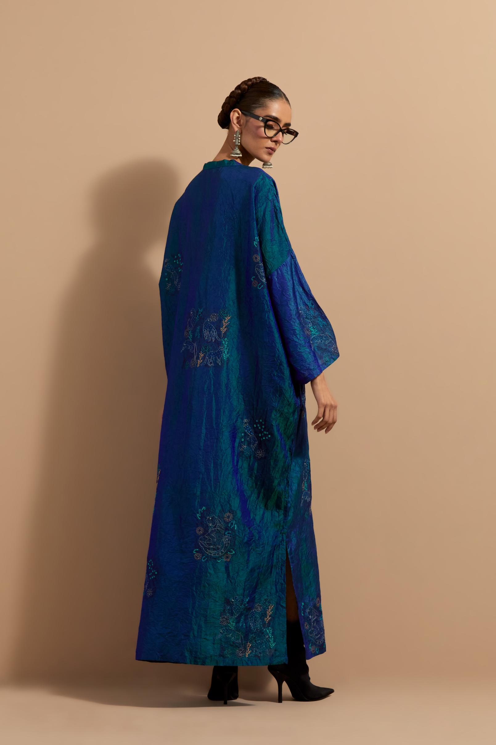 Teal blue crushed silk hand block printed long kaftan, highlighted with multi colored thread embroidery, paired with Red hand crushed block printed silk stole with quilted embroidery and beaded tassels.