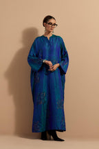 Teal blue crushed silk hand block printed long kaftan, highlighted with multi colored thread embroidery, paired with Red hand crushed block printed silk stole with quilted embroidery and beaded tassels.