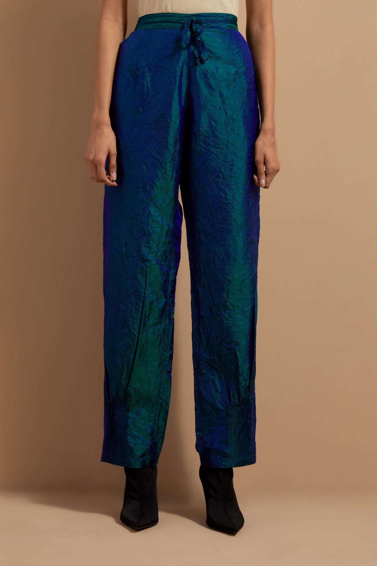 Teal blue crushed silk hand block printed pants with pin tucks detailing at hem.