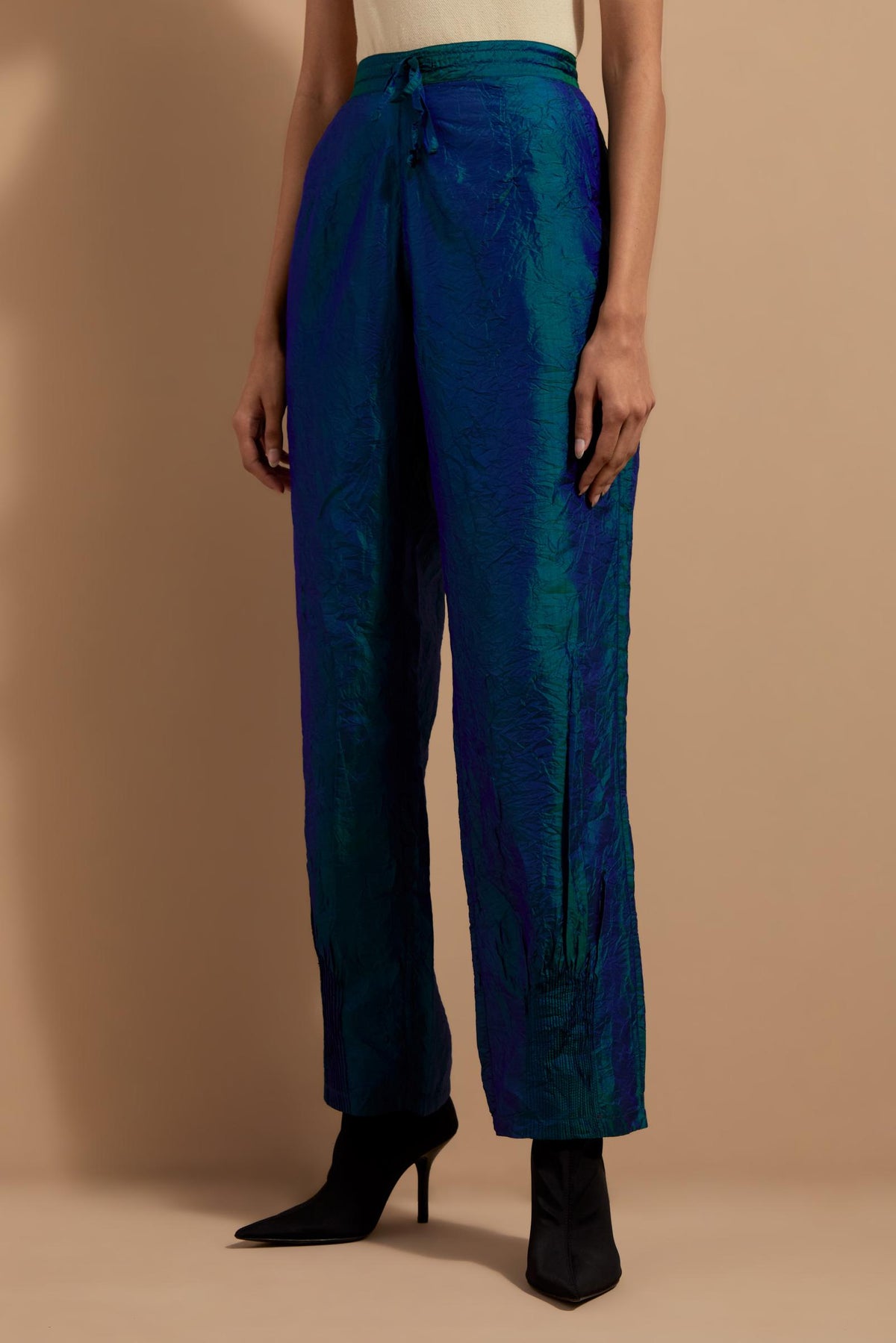 Teal blue crushed silk hand block printed pants with pin tucks detailing at hem.