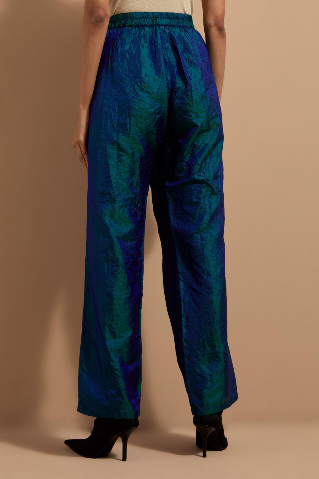 Teal blue crushed silk hand block printed pants with pin tucks detailing at hem.