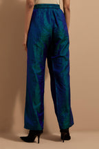 Teal blue crushed silk hand block printed pants with pin tucks detailing at hem.