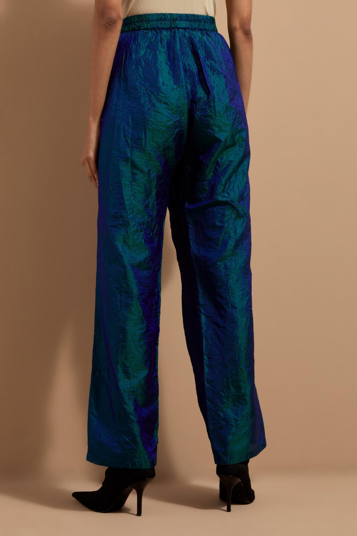 Teal blue crushed silk hand block printed pants with pin tucks detailing at hem.