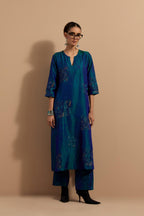 Teal blue crushed silk hand block printed straight kurta set, highlighted with multi colored thread embroidery.