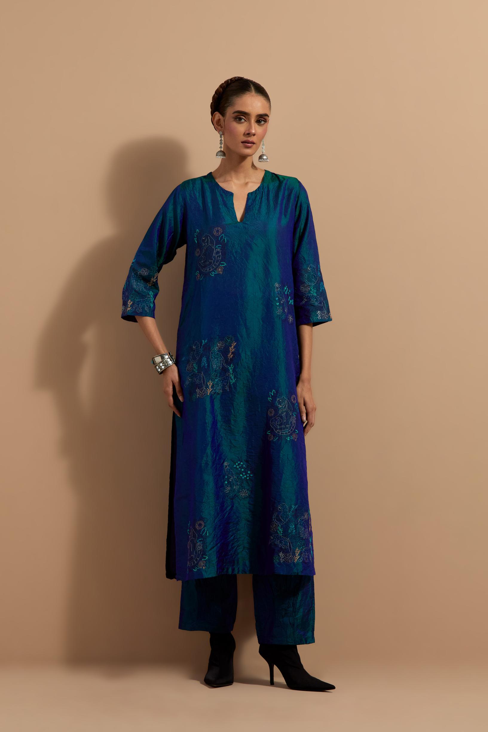 Teal blue crushed silk hand block printed straight kurta set, highlighted with multi colored thread embroidery.