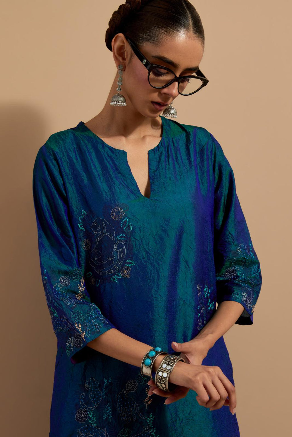 Teal blue crushed silk hand block printed straight kurta set, highlighted with multi colored thread embroidery.