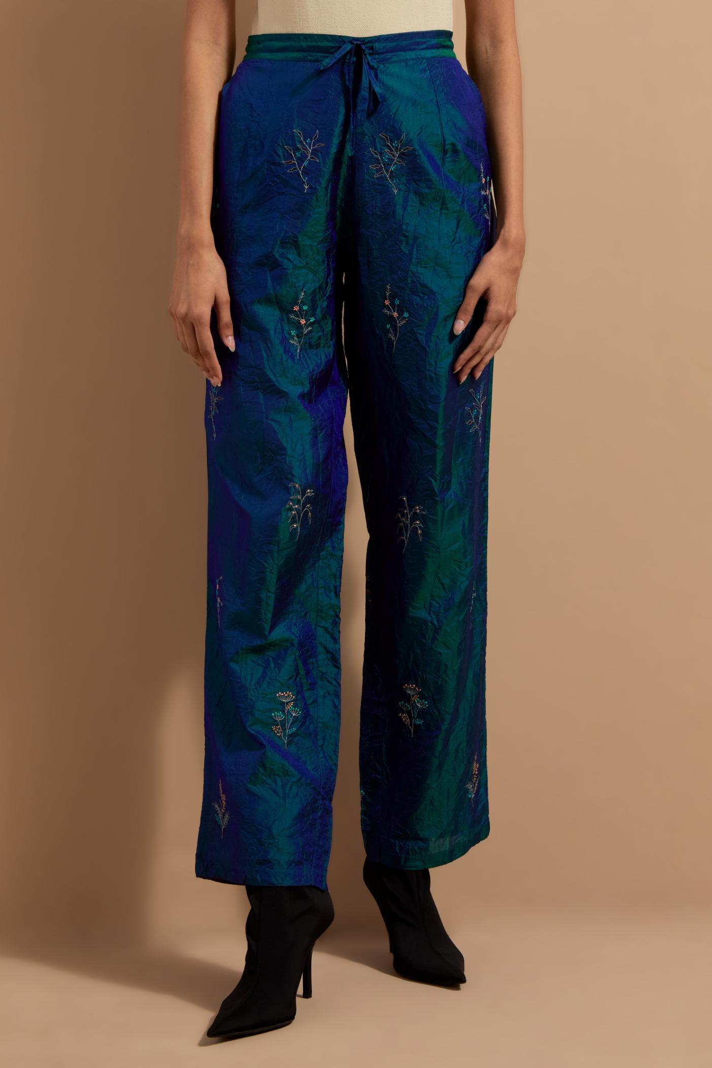 Teal blue crushed silk hand block printed pants, highlighted with multi colored thread embroidery.