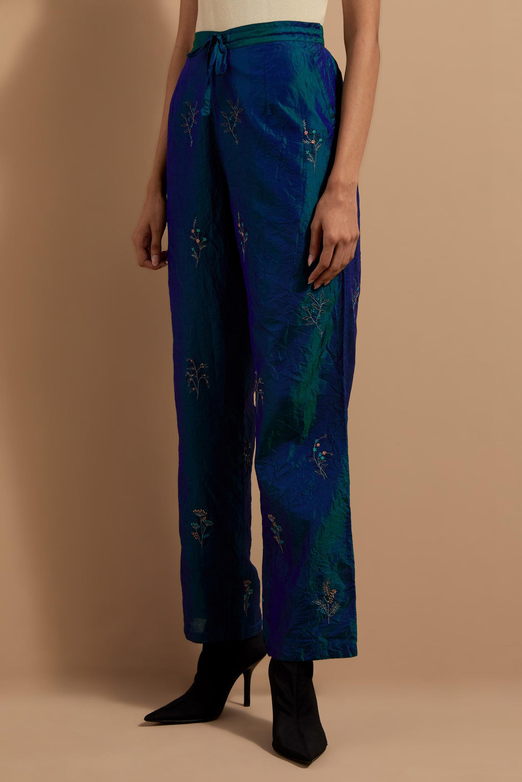 Teal blue crushed silk hand block printed pants, highlighted with multi colored thread embroidery.