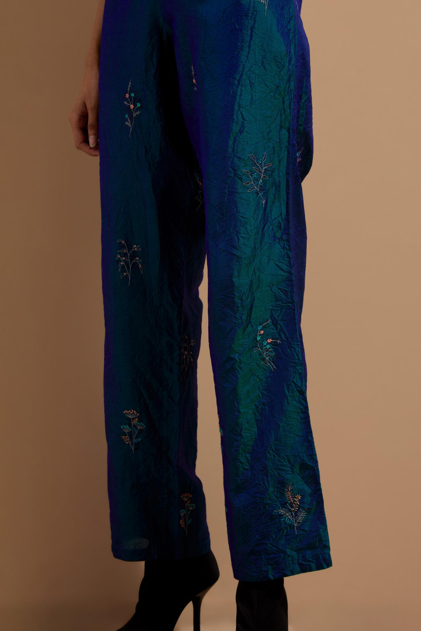 Teal blue crushed silk hand block printed pants, highlighted with multi colored thread embroidery.