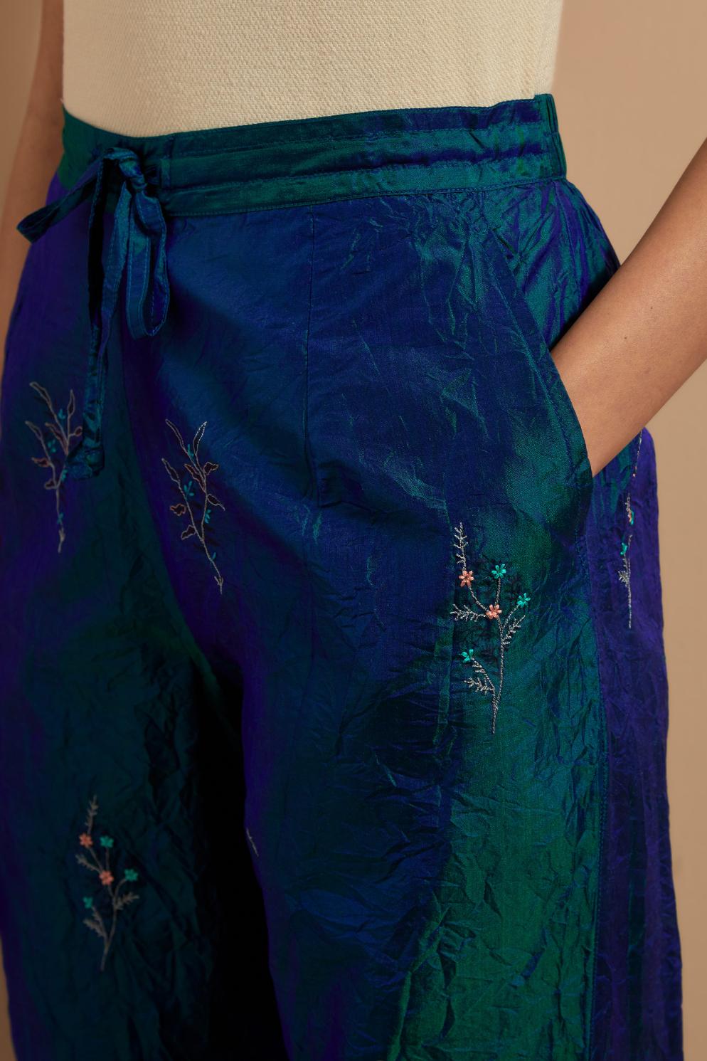Teal blue crushed silk hand block printed pants, highlighted with multi colored thread embroidery.