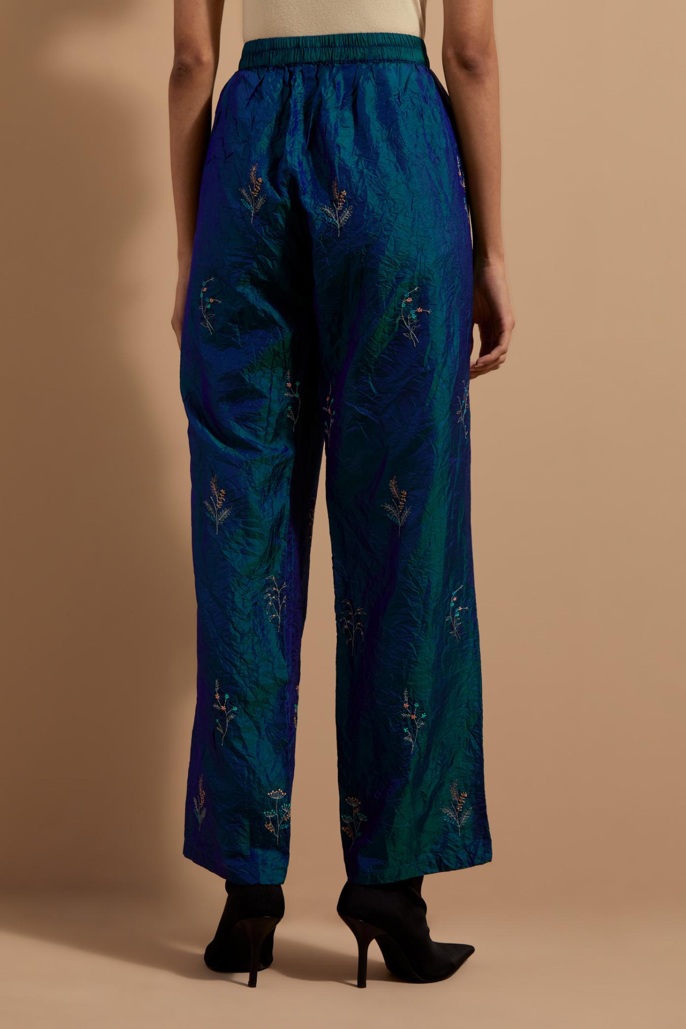 Teal blue crushed silk hand block printed pants, highlighted with multi colored thread embroidery.
