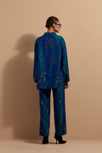 Teal blue crushed silk hand block printed shirt, highlighted with multi colored thread embroidery, paired with Teal blue crushed silk hand block printed pants, highlighted with multi colored thread embroidery.
