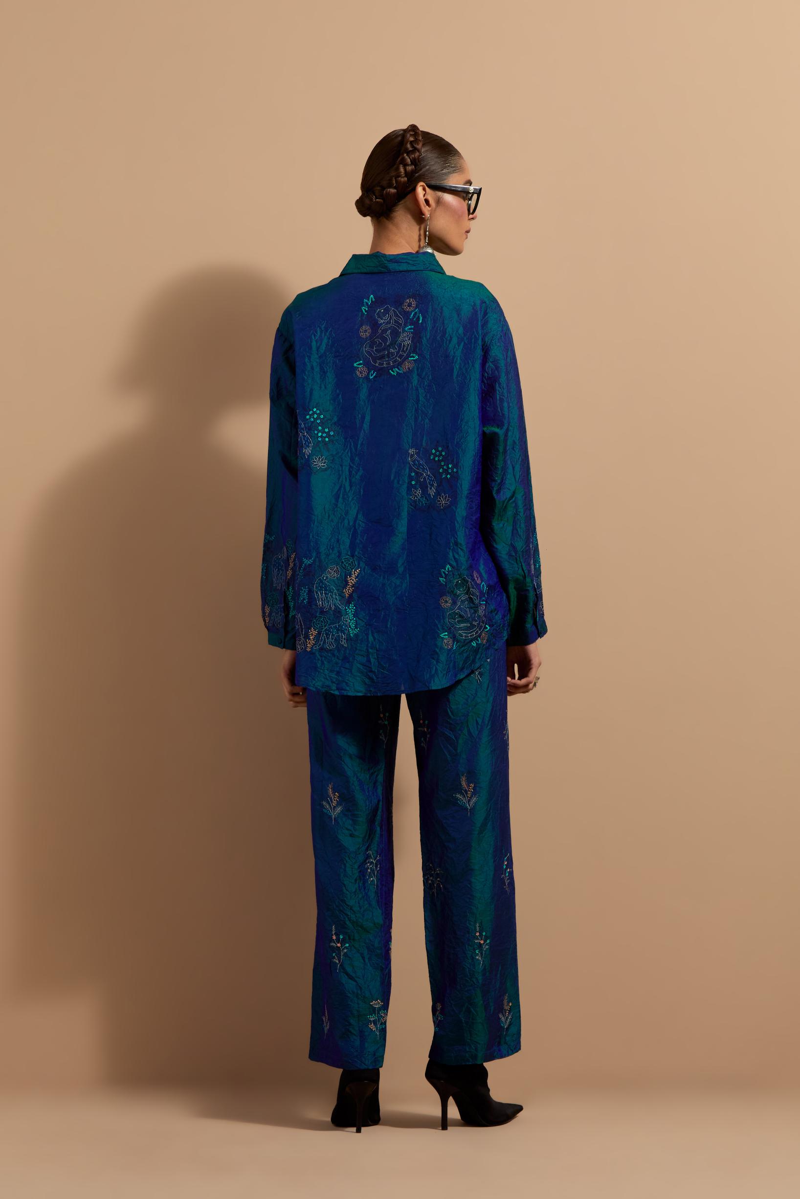 Teal blue crushed silk hand block printed shirt, highlighted with multi colored thread embroidery, paired with Teal blue crushed silk hand block printed pants, highlighted with multi colored thread embroidery.