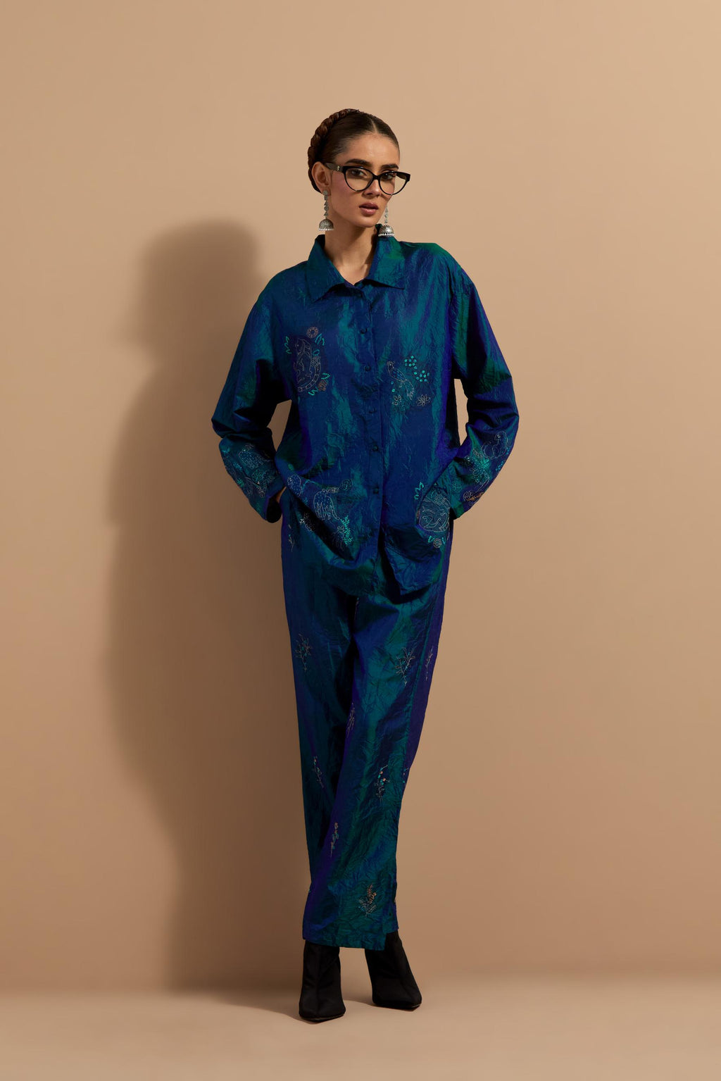 Teal blue crushed silk hand block printed shirt, highlighted with multi colored thread embroidery, paired with Teal blue crushed silk hand block printed pants, highlighted with multi colored thread embroidery.
