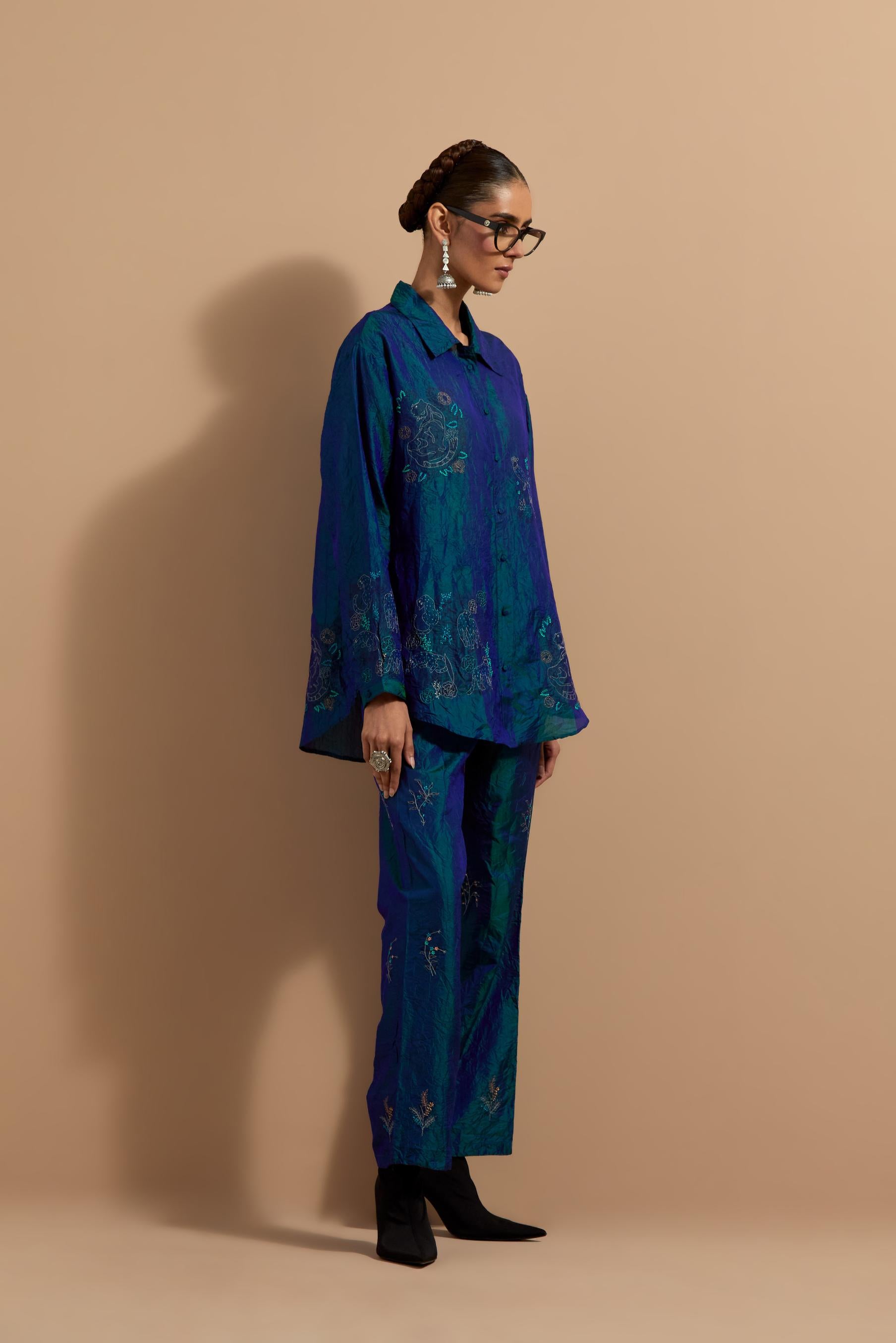 Teal blue crushed silk hand block printed shirt, highlighted with multi colored thread embroidery, paired with Teal blue crushed silk hand block printed pants, highlighted with multi colored thread embroidery.