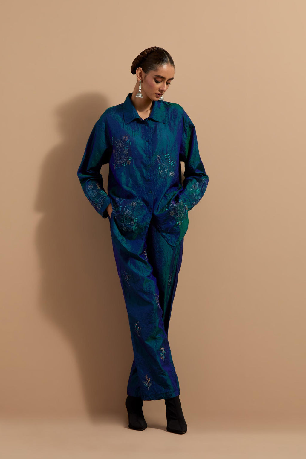 Teal blue crushed silk hand block printed shirt, highlighted with multi colored thread embroidery, paired with Teal blue crushed silk hand block printed pants, highlighted with multi colored thread embroidery.