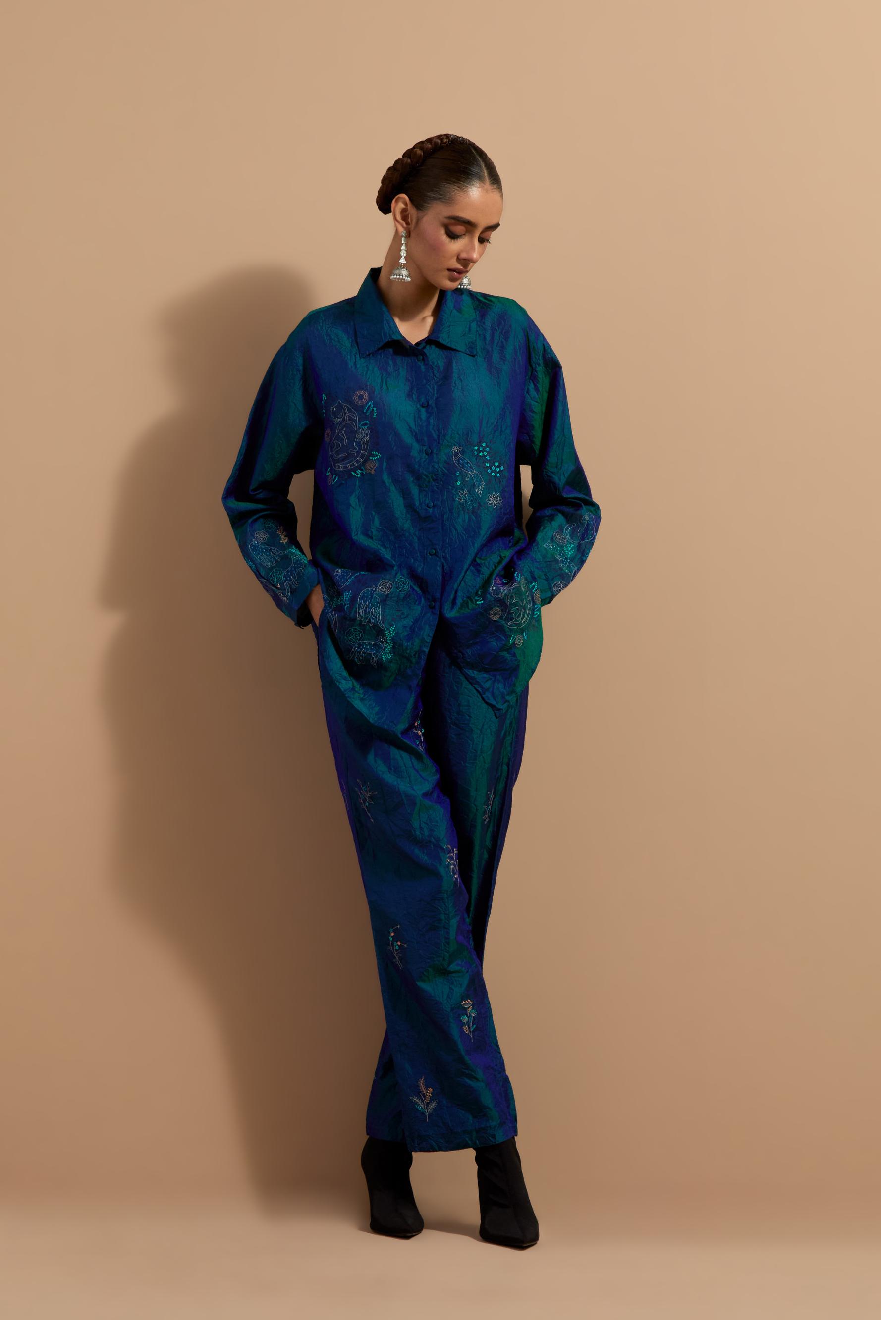Teal blue crushed silk hand block printed shirt, highlighted with multi colored thread embroidery, paired with Teal blue crushed silk hand block printed pants, highlighted with multi colored thread embroidery.