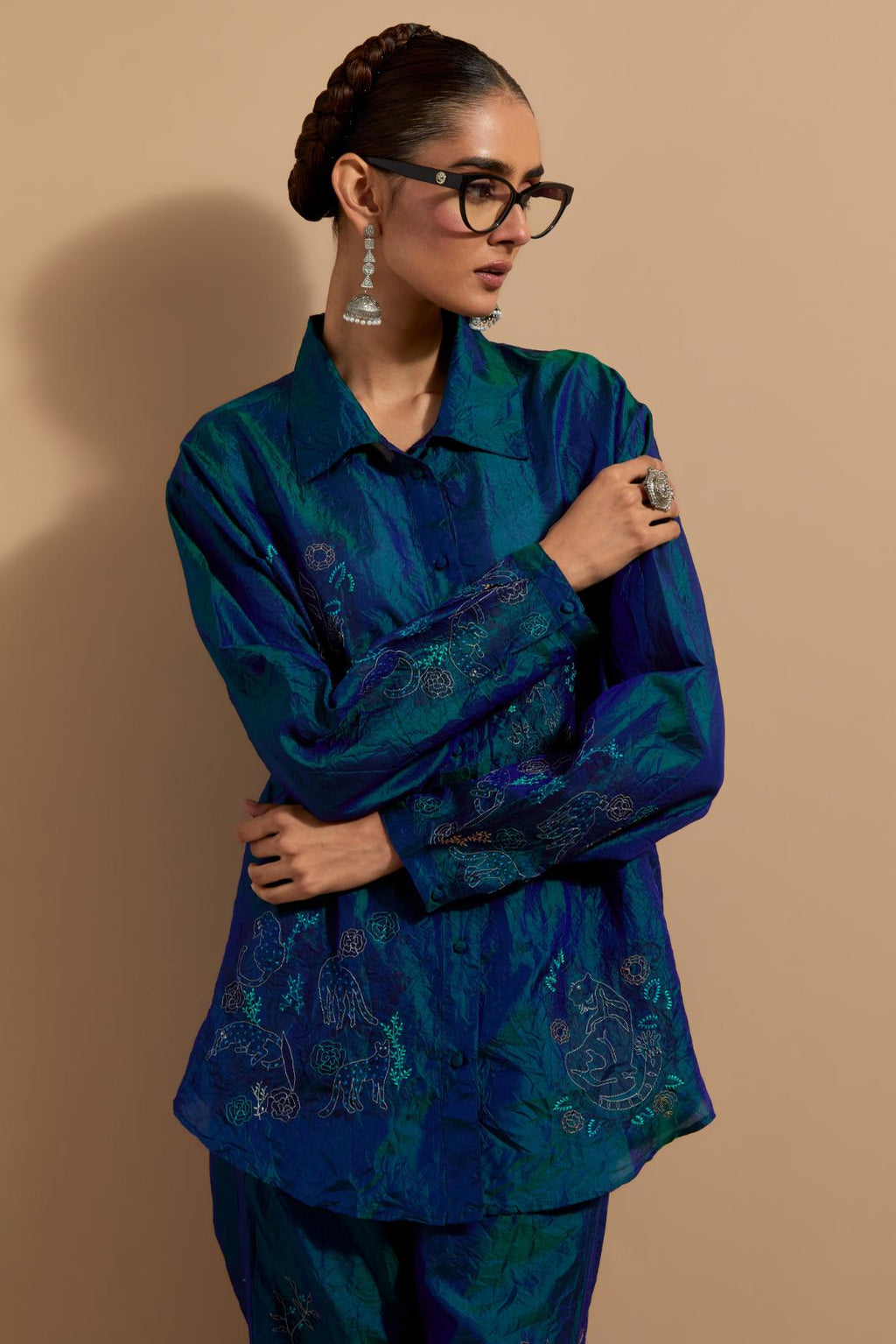 Teal blue crushed silk hand block printed shirt, highlighted with multi colored thread embroidery, paired with Teal blue crushed silk hand block printed pants, highlighted with multi colored thread embroidery.
